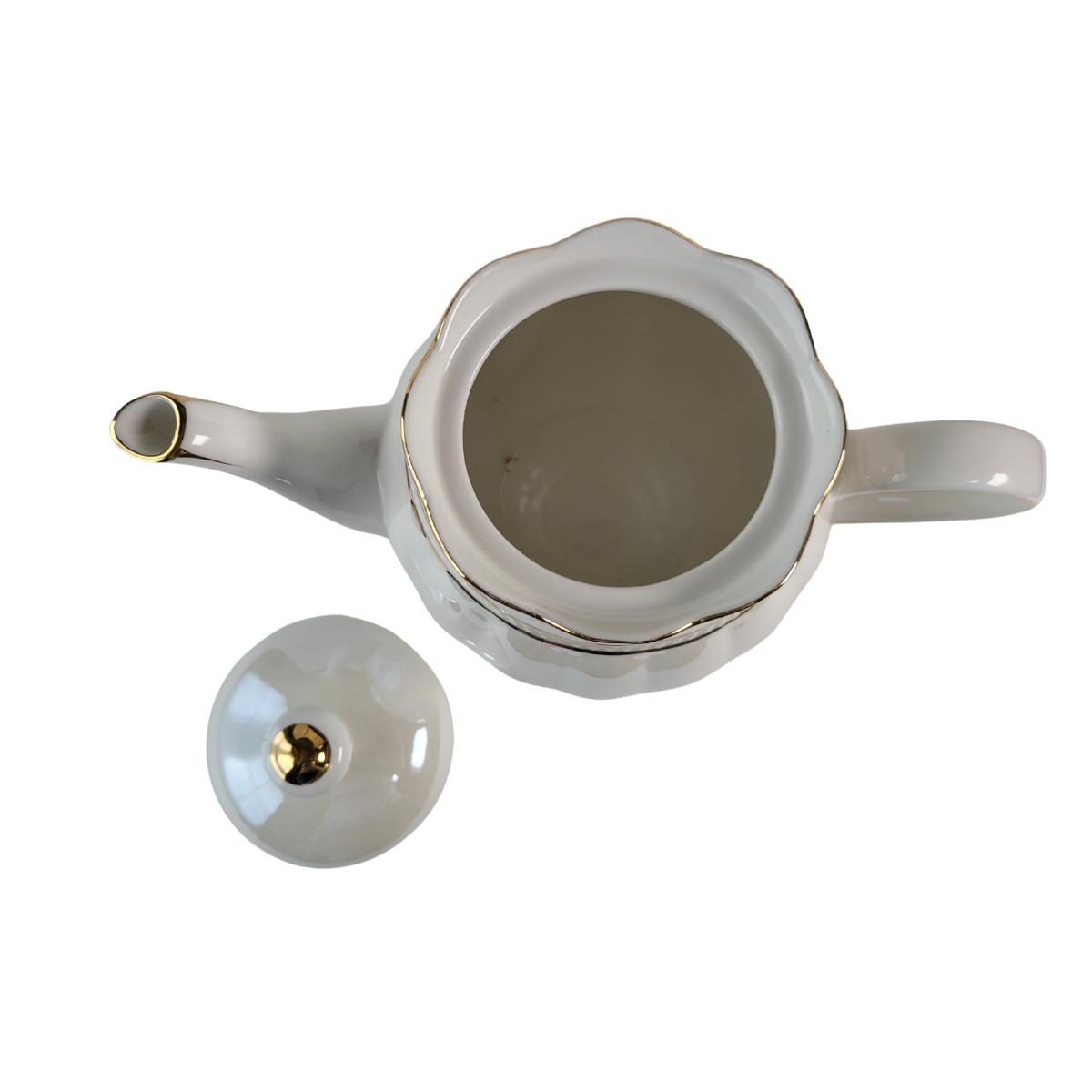 Top-down inside view of a Luster Gold Porcelain gold trimmed teapot with lid off all on a white background