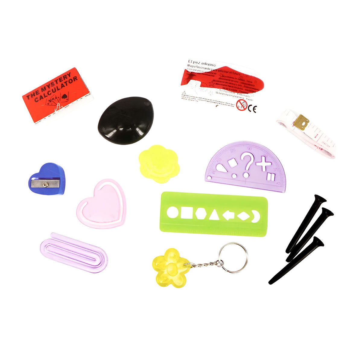 Collection of stationery items including calculators, sharpener, and various shaped tools on a white background