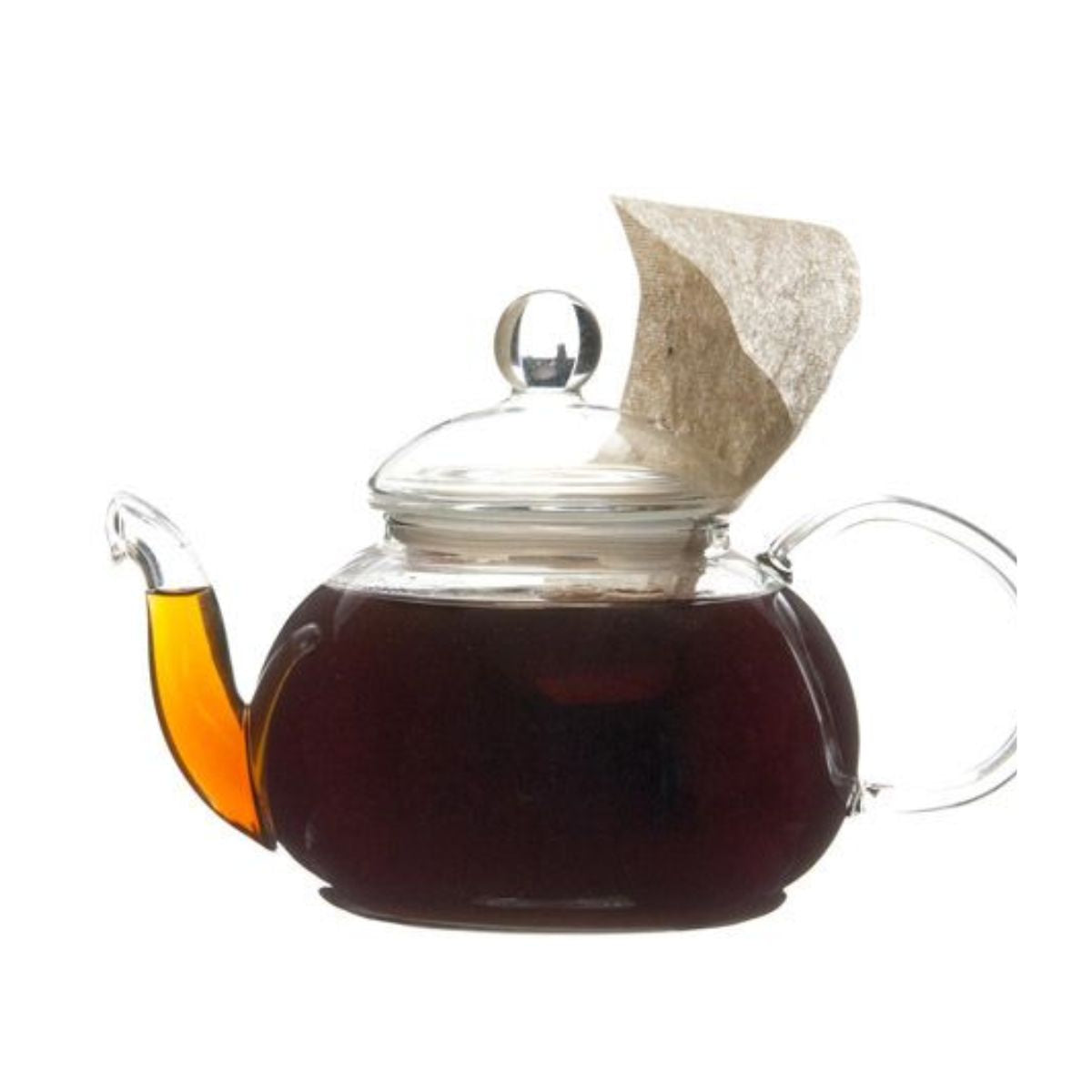 Glass teapot filled with dark hot tea and a teabag.