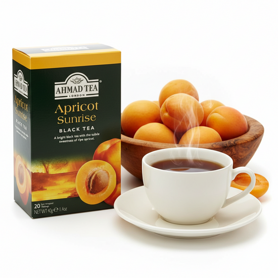 Ahmad Tea Apricot Sunrise black tea box with a steaming cup of tea and apricots on a white background