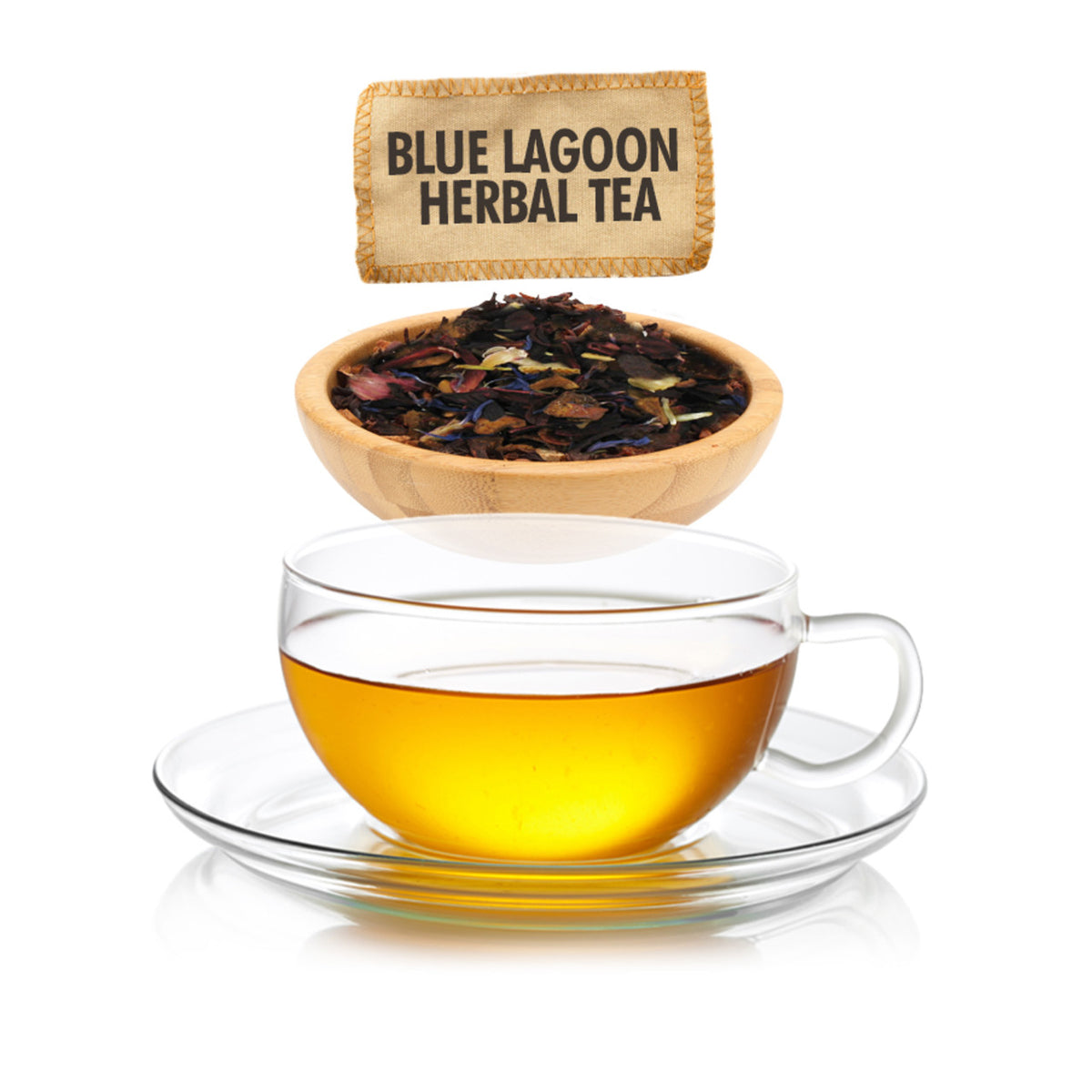 Clear glass cup of tea with a wooden bowl of tea leaves and a 'Blue Lagoon Herbal Tea' package on a white background.