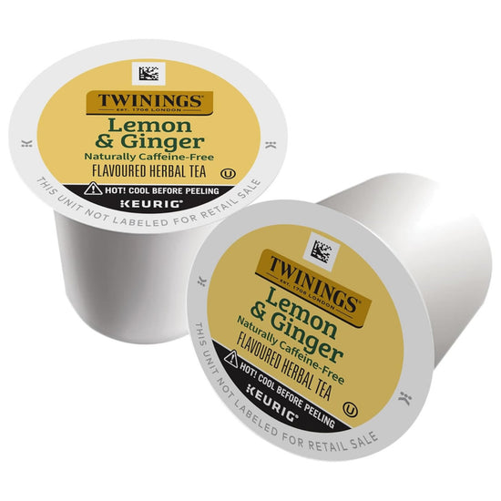 Two Twinings Lemon & Ginger tea capsules on a white background
