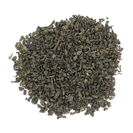 A pile of dry, rolled Gunpowder Green Tea leaves.
