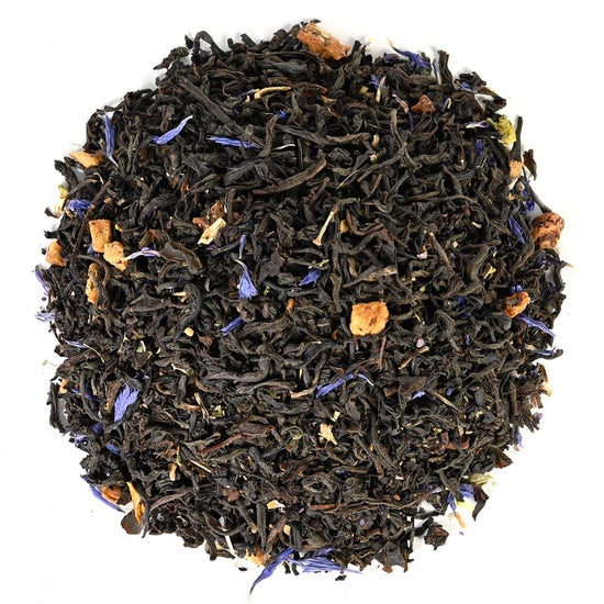 Tea leaves with visible herbs and flowers on a white background