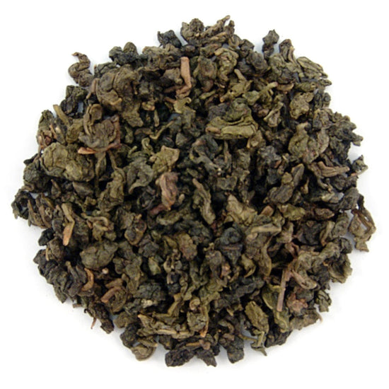Dry green tea leaves on a white background
