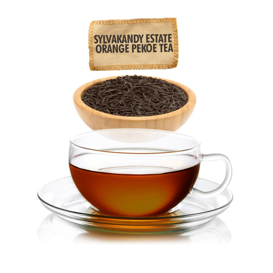 Glass cup of tea with a bowl of tea leaves and a package labeled 'Sylvakandy Estate Orange Pekoe Tea'.