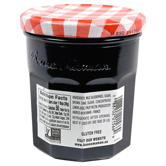 Back of a jar of Bonne Maman Blueberry preserves on a white background featuring a red and white checkered lid and a label with nutrition facts and ingredients.