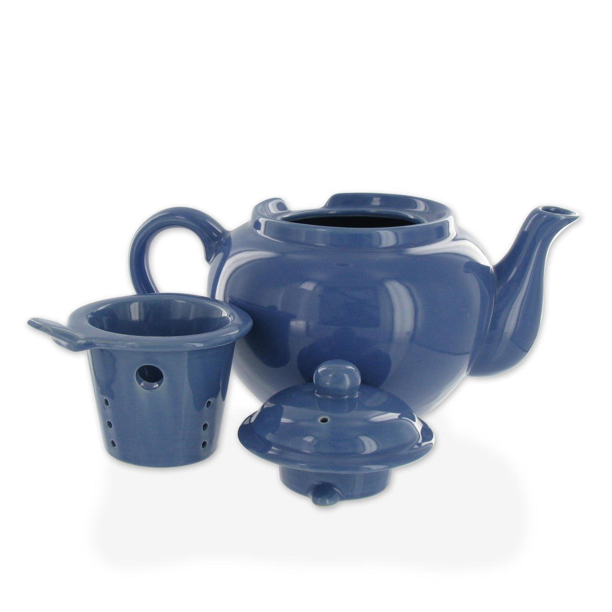 Blue ceramic teapot with accessories on a white background