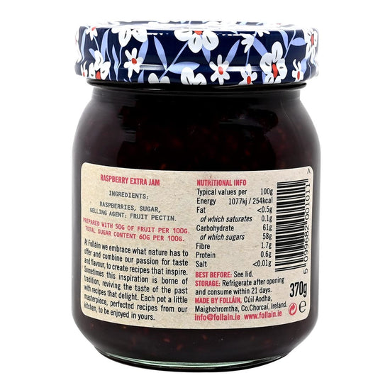 Back label of a jar of Follain raspberry extra jam with decorative lid on a white background