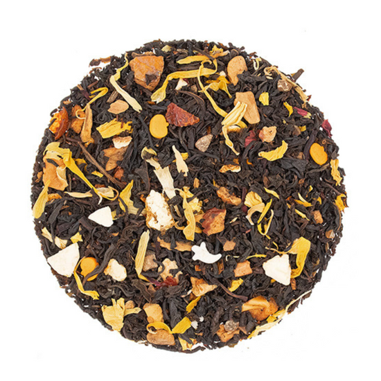 Tea ball with black tea leaves and various dried fruit pieces on a white background