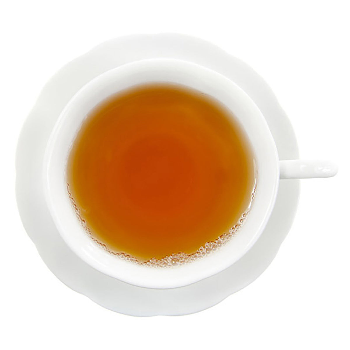top-down view of light amber hot tea in a white teacup on a white saucer on a white background