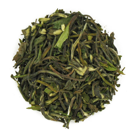 Close-up of green tea leaves on a white background