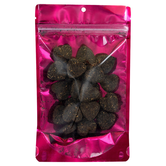 Pink transparent bag with Yunnan tea pressed into hearts with bag on a white background.