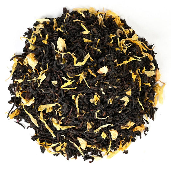 Loose-leaf black tea mixed with yellow petals and dried fruit pieces.