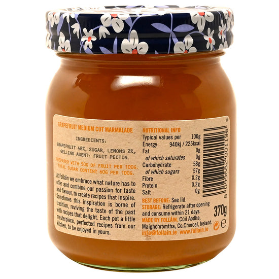 Jar of Follain grapefruit marmalade with floral lid on a white background