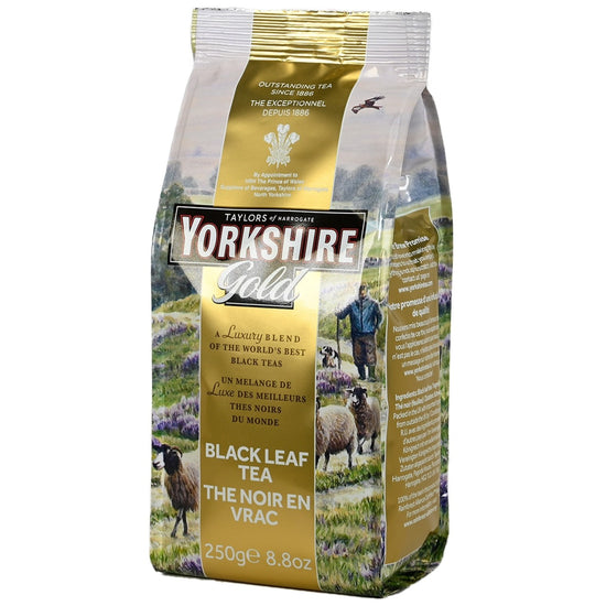 A package of Taylors of Harrogate Yorkshire Gold featuring a scenic landscape with sheep and a gold stripe