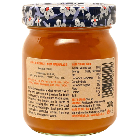 Jar of Folláin marmalade with a floral lid, showing nutritional information on the label.