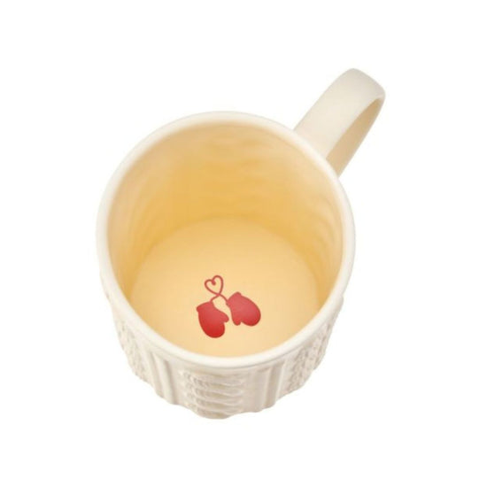 White mug with a decorative handle on a white background