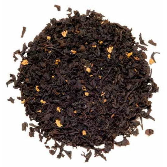 Close-up of black tea leaves on a white background