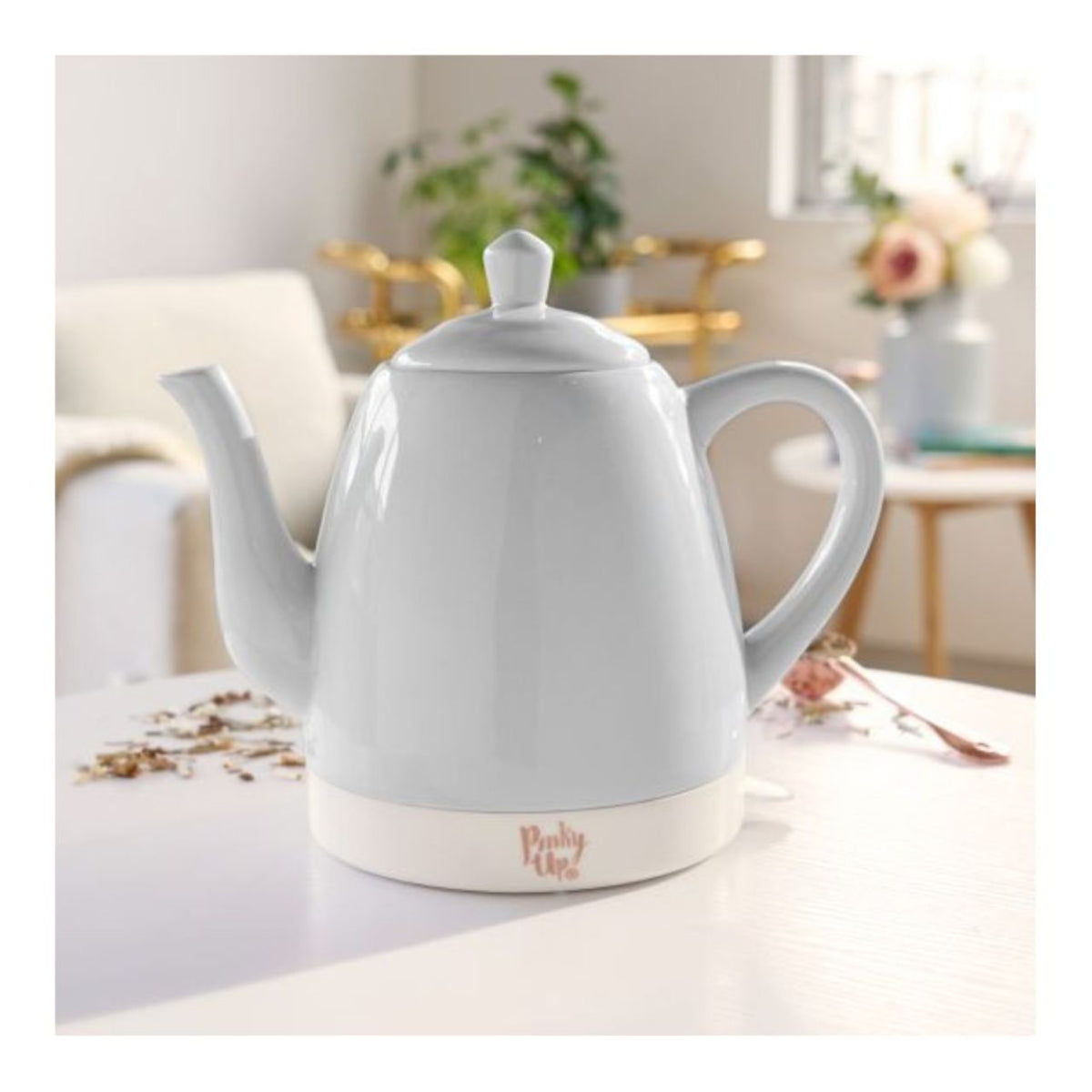 White electric kettle on a table with a blurred background
