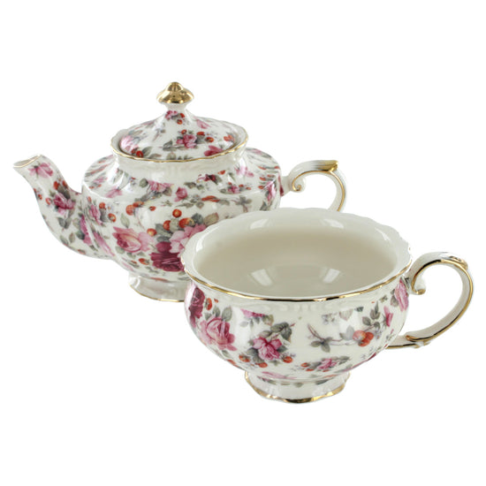Floral porcelain teapot and cup set on a white background
