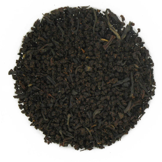 Close-up of black tea leaves on a white background