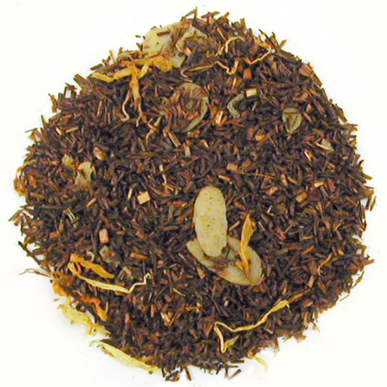 A close-up of Bourbon St. Vanilla Rooibos loose leaf tea with visible pieces of almond and vanilla throughout the dark reddish-brown leaves.