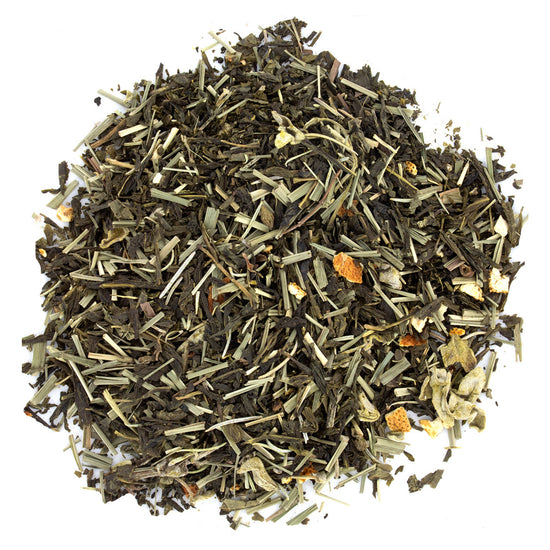 A pile of loose leaf tea with visible green tea leaves, pieces of lemongrass, and dried citrus fruit.