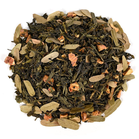 Tea blend with green leaves and dried flowers on a white background
