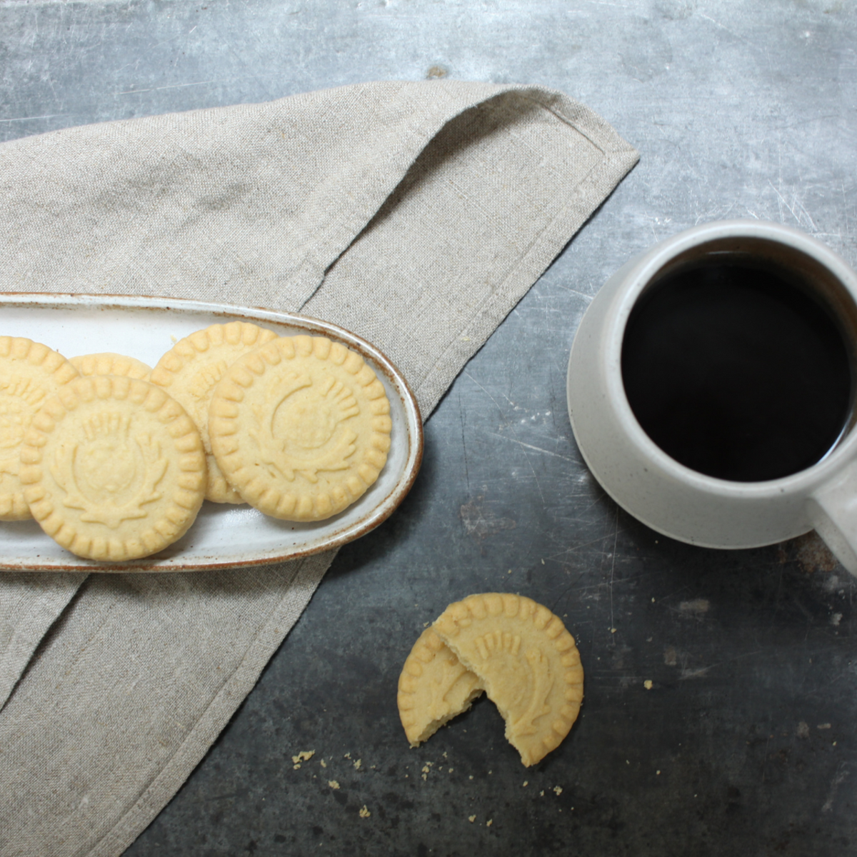 A top-down view of shortbread cookies and a cup of black tea