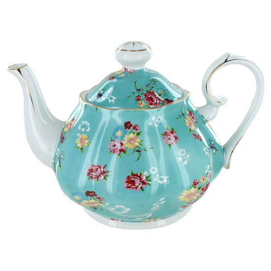 Turquoise porcelain teapot with floral design on a white background
