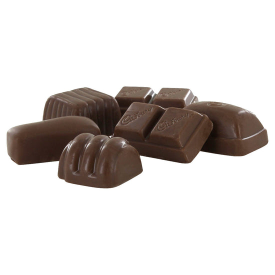 Unwrapped individual pieces of Cadbury chocolate on a white background.