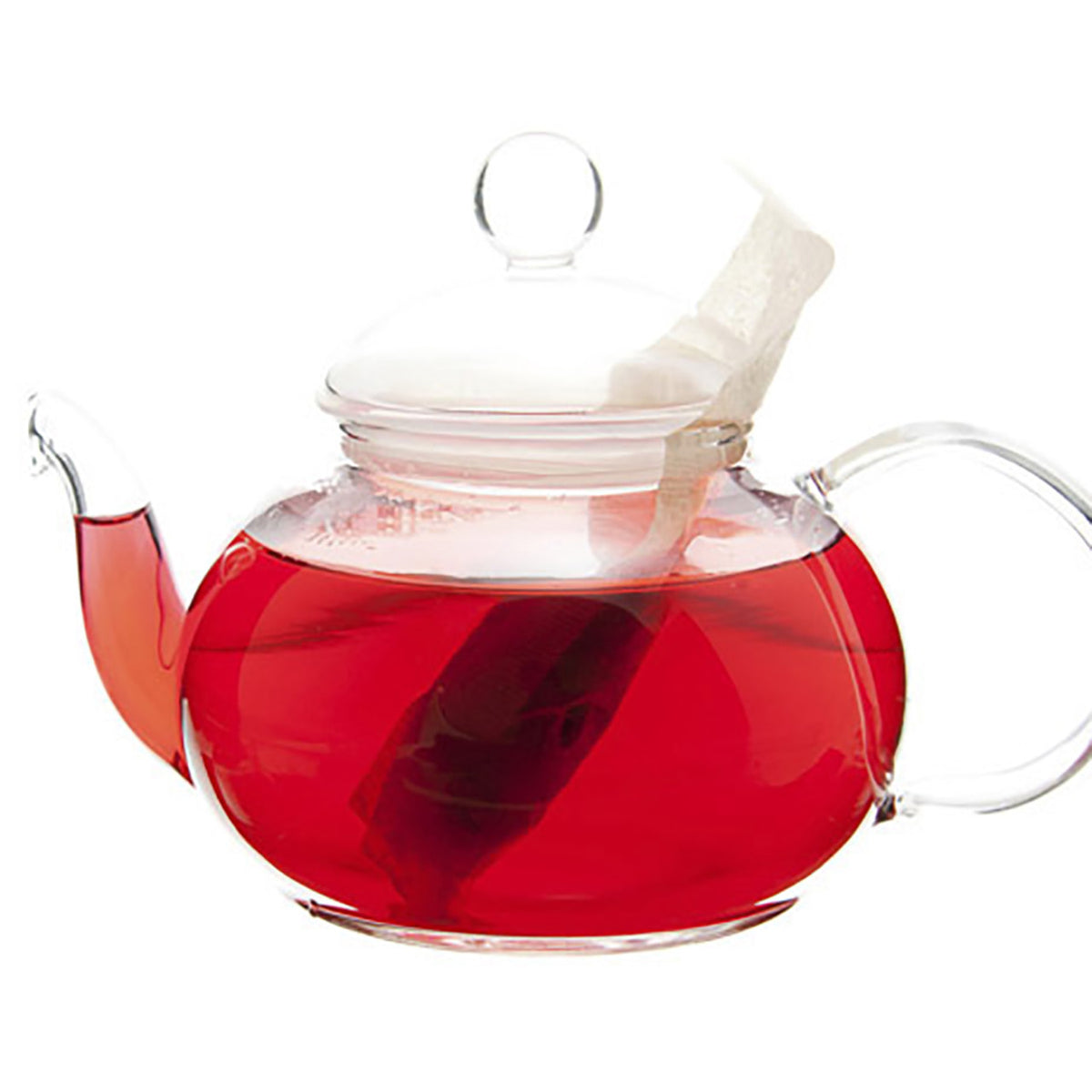 Glass teapot filled with red colored tea and a teabag on a white background