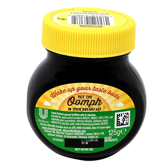Jar of Marmite with yellow lid on a white background