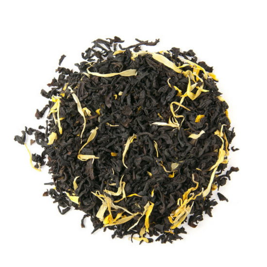 Black tea leaves with yellow strands on a white background