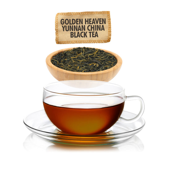 Glass teacup with black tea, a wooden bowl of tea leaves, and a tea bag labeled 'Golden Heaven Yunnan China Black Tea' on a white background.