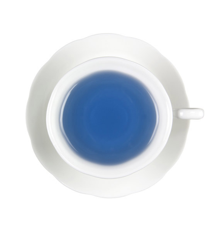 White ceramic teacup with blue liquid hot tea on a white background