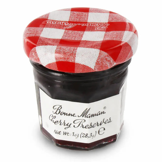 Jar of Bonne Maman Cherry Preserves with a red and white checkered lid on a white background