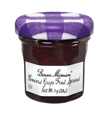 Jar of Bonne Maman Concord Grape Fruit Spread with a purple checkered lid on a white background