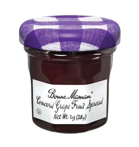 Jar of Bonne Maman Concord Grape Fruit Spread with a purple checkered lid on a white background