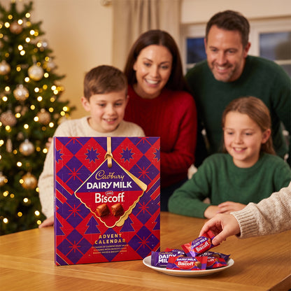 Family at a table with a Christmas tree, a boy opening a Cadbury Dairy Milk Biscoff Advent Calendar and sharing chocolates