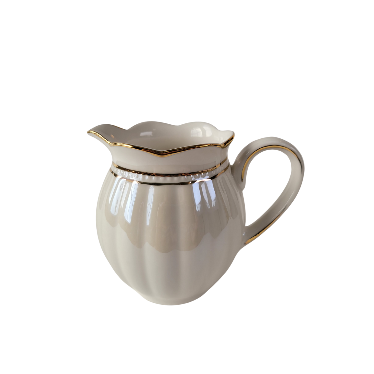 Side view of a Luster Gold Porcelain gold trimmed creamer on a white background