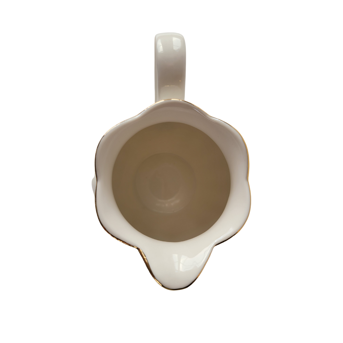 Top-down view of the inside of a Luster Gold Porcelain gold trimmed creamer on a white background