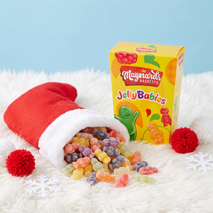Christmas stocking spilling jelly babies with a Maynards Jelly Babies box on a fluffy white surface.