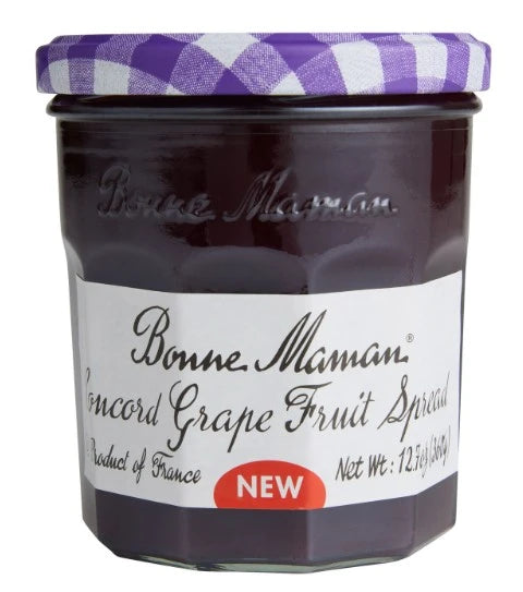 Jar of Bonne Maman Concord Grape Fruit Spread with a purple checkered lid on a white background
