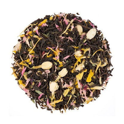 Dry ball of loose-leaf black tea leaves and colorful flowers on a white background