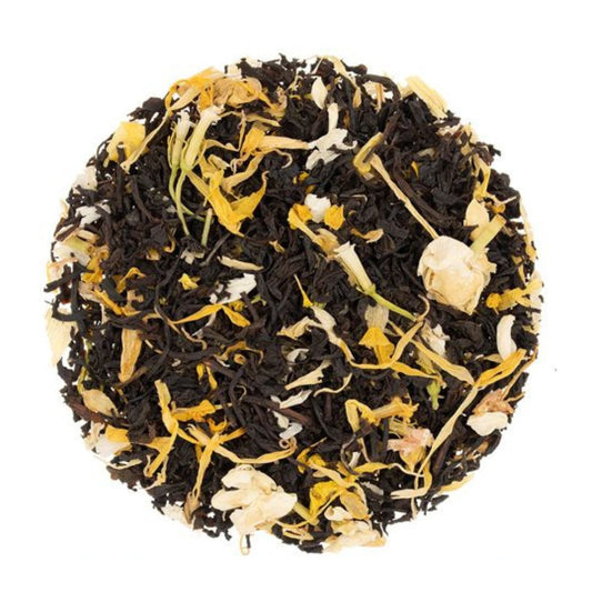 Dry loose-leaf black tea mixed with yellow petals and dried yellow fruit pieces.