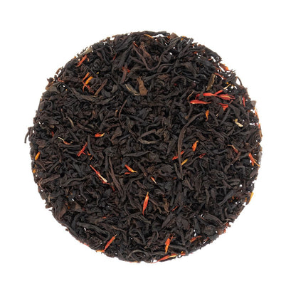 Round tea ball of Sugar Shack Smokey Maple black and red tea leaves on a white background