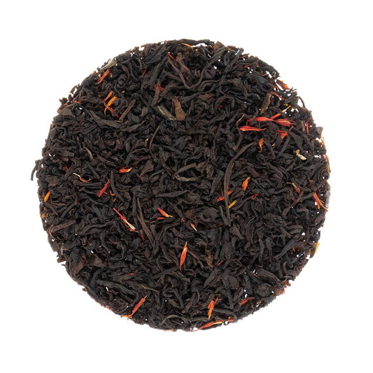 Round tea ball of Sugar Shack Smokey Maple black and red tea leaves on a white background