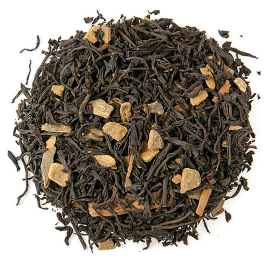 Tea leaves with gold pieces on a white background